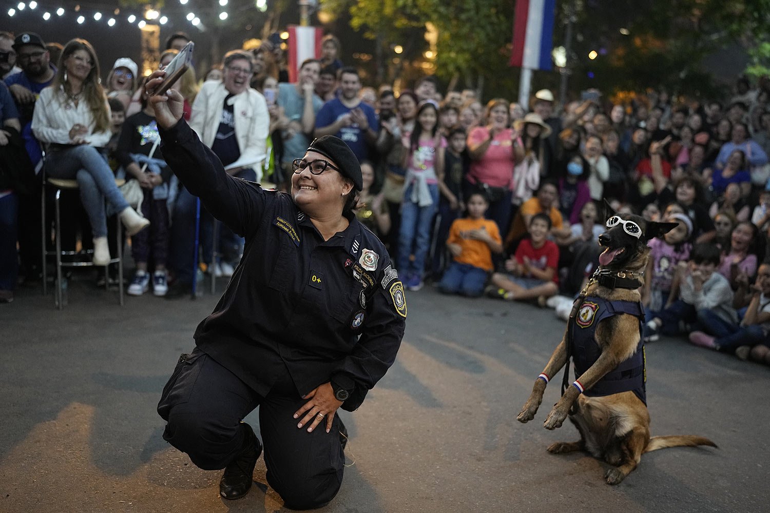  Handler Adriana Ayala poses for a selfie with her police dog during an exhibition celebrating Paraguay’s 212th Independence from Spain, in Asuncion, May 14, 2023. (AP Photo/Jorge Saenz) 