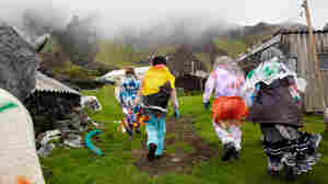 A group of Okalolies head toward a house belonging to one of their own in Edinburgh of the Seven Seas on Tristan da Cunha, in the South Atlantic Ocean, on Dec. 31, 2023. New Year's Eve, or Old Year's Night as it's known on the island, is a chance for the whole community to come together.
