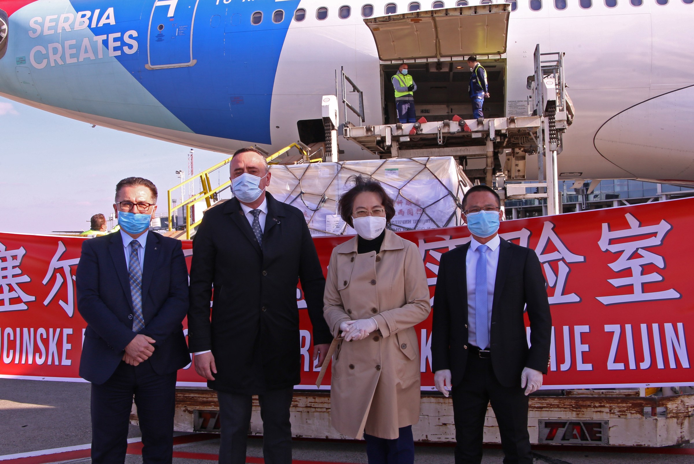 Serbian Minister of Mining and Energy Aleksandar Antić and Chinese Ambassador to Serbia Chen Bo pose for a photo in front of an airplane carrying equipment for new Serbian Covid-19 labs in Belgrade, Serbia, on April 15, 2020.