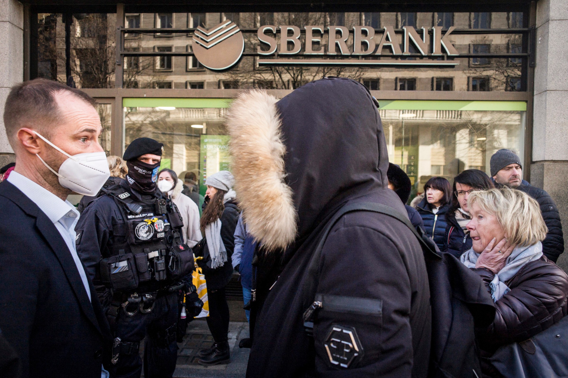 People line up outside a branch of the Russian state-owned bank Sberbank to withdraw their savings and close their accounts in Prague, Czech Republic, on February 25.