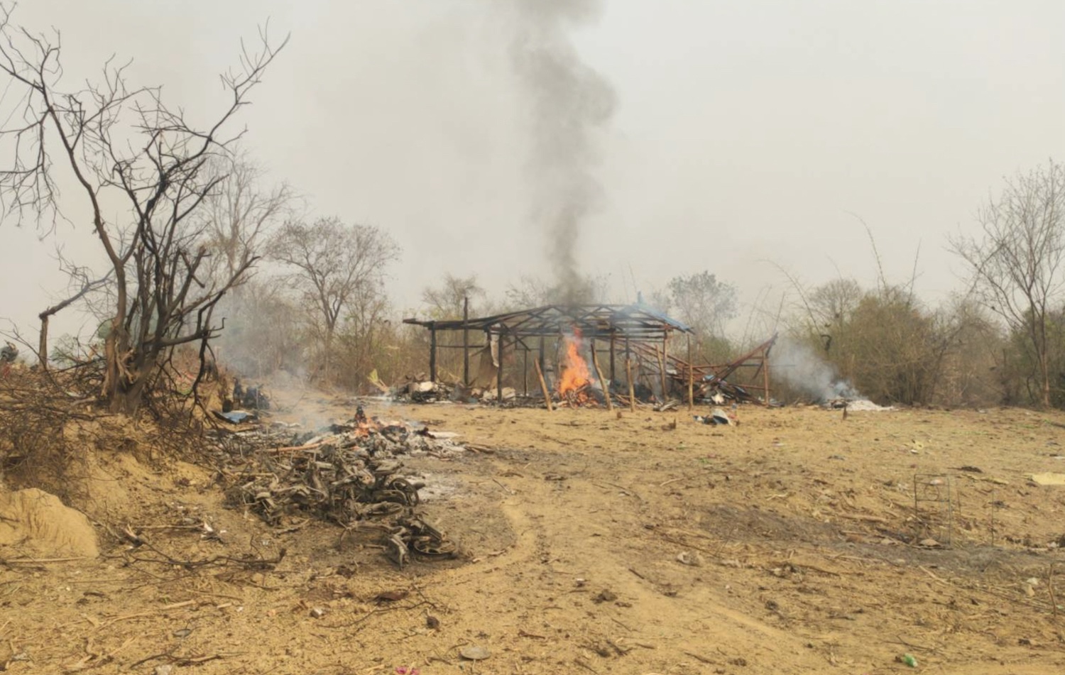 A fire burns following an aerial attack by the Myanmar military that killed about 160 people, including 40 children, in Pazigyi village in Sagaing Region of Myanmar in April 2023.