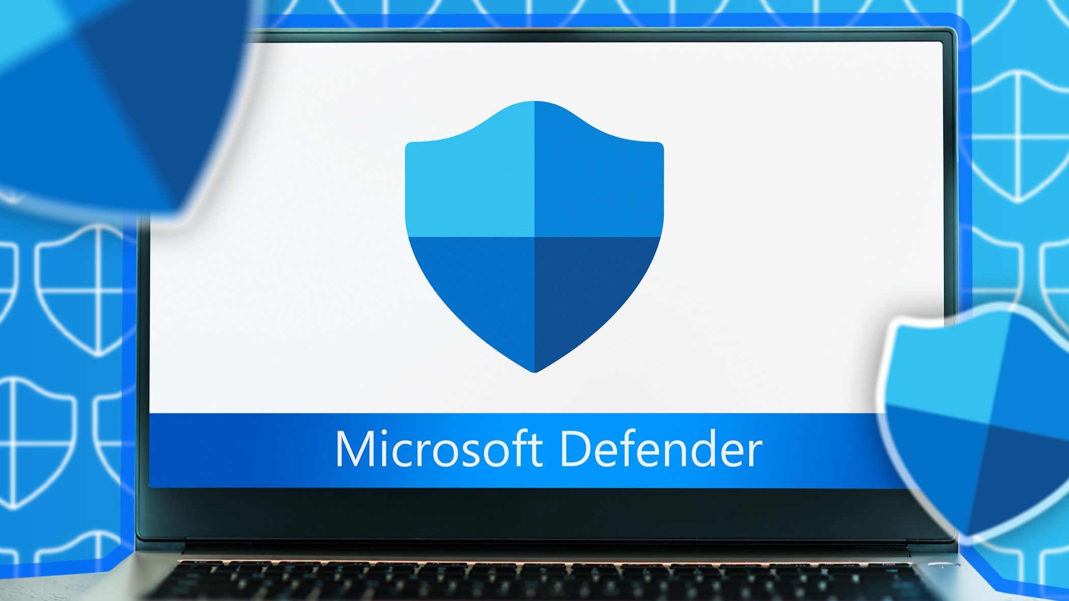 A laptop with Microsoft Defender icon on the screen.