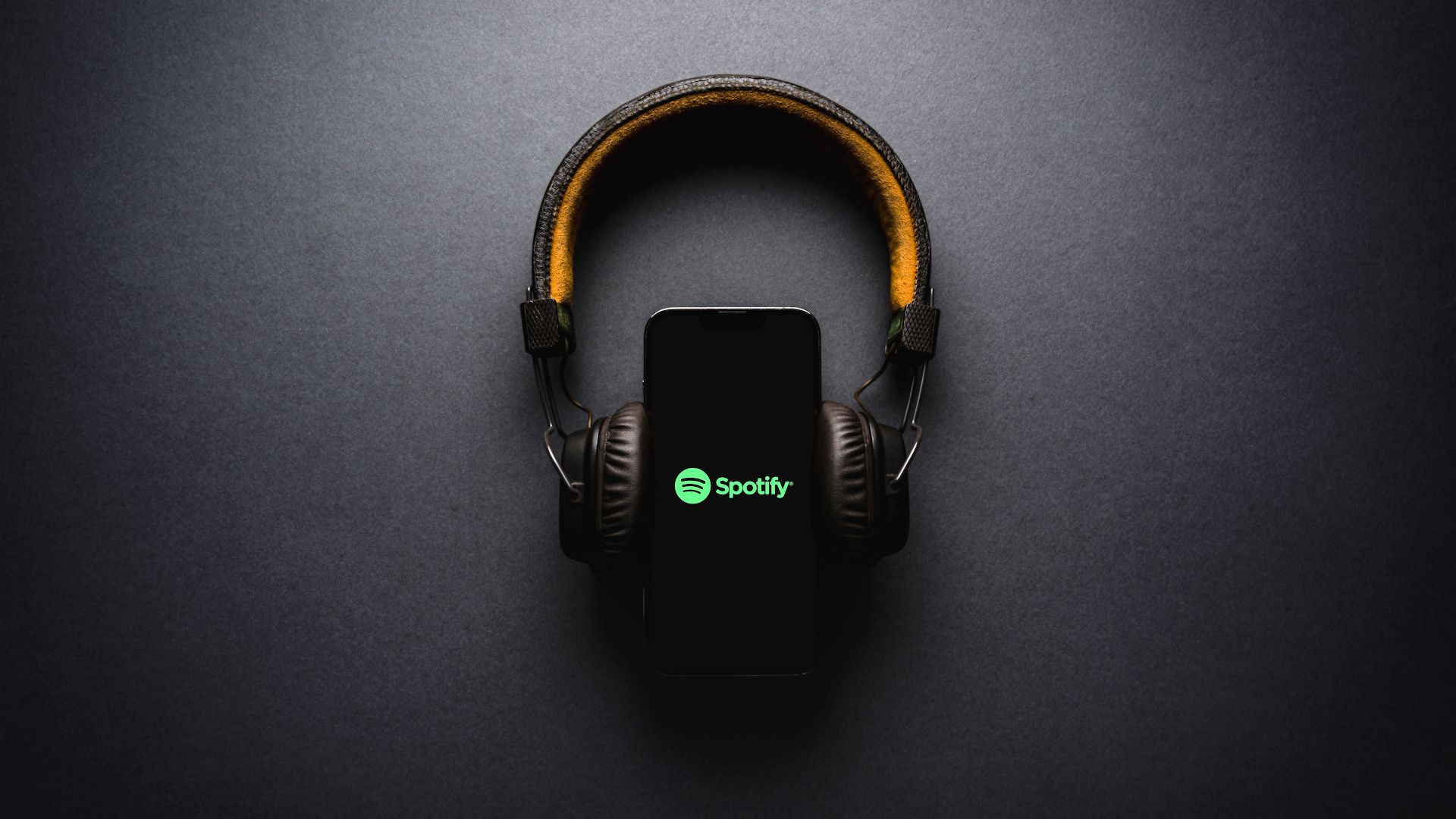 spotify logo on smartphone with headphones