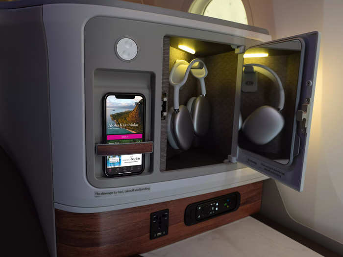Each business-class seat has an 18-inch screen, personal outlets, and wireless charging.