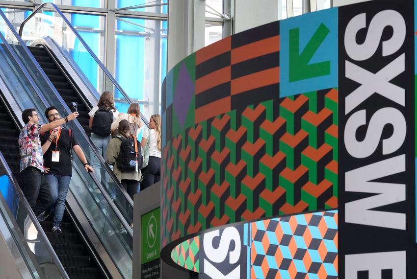 From left: Fernando Antunes and Bruno Stefani, both of Sao Paolo, Brazil, video record themselves on the escalator at SXSW at the Austin Convention Center on March 8, 2024.