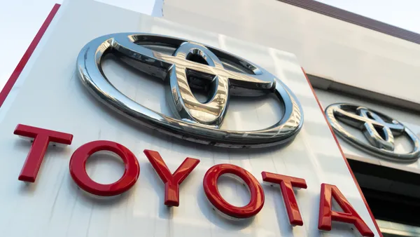 The Toyota logo on a sign at a dealership.