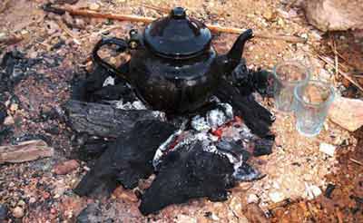 traditional Libyan tea pot, gently bubbling on embers