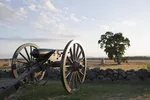Cannon facing the horizon over a low stone wall