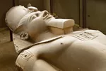 A limestone statue of Ramses II, lying on display